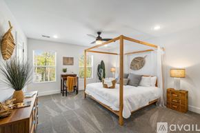 North Charleston townhouse for rent - A bedroom with a four poster bed and a ceiling fan.