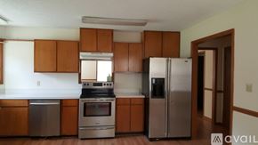 Dublin house for rent - A kitchen with brown cabinets and stainless steel appliances.