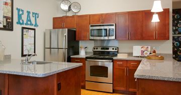 Pittsburgh apartment for rent - a kitchen with stainless steel appliances and granite counter tops