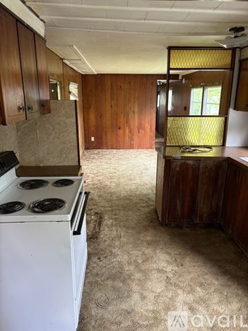 Seville house for rent - A kitchen with a white stove and wooden cabinets.