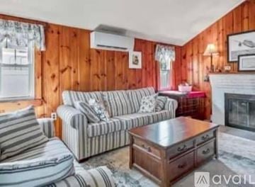 Scarborough house for rent - A living room with a striped couch and a wooden coffee table.