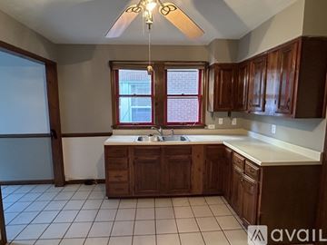 West Carrollton house for rent - A kitchen with brown cabinets and a white countertop.