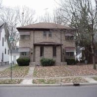 East Lansing house for rent - A house with a brown roof and a white fence.