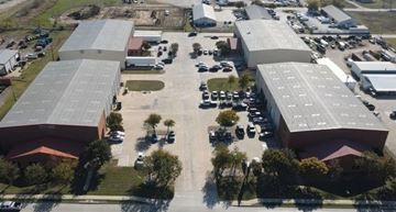Denton apartment for rent - An aerial view of a parking lot with several cars and buildings.