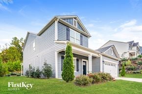 Helena house for rent - A house with a grey exterior and a white garage door is for sale.