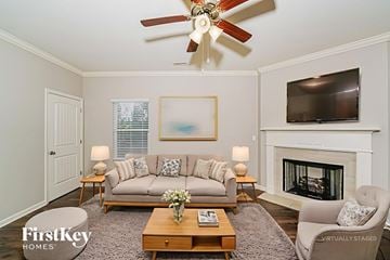 Helena house for rent - A living room with a fireplace and a television on the wall.