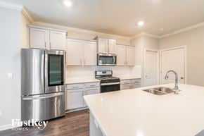 Helena house for rent - A kitchen with a stainless steel refrigerator, microwave, and oven.