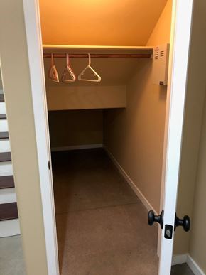 Flagstaff house for rent - A white door is open to a hallway with a coat rack.