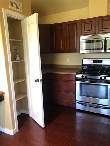 Flagstaff house for rent - A kitchen with a stove and an open door.