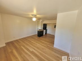 Escondido house for rent - A room with a ceiling fan and wooden flooring.