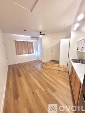 Escondido house for rent - A kitchen with a white fridge, wooden floors, and a window.