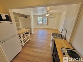 Escondido house for rent - A kitchen with a white fridge and wooden floors.