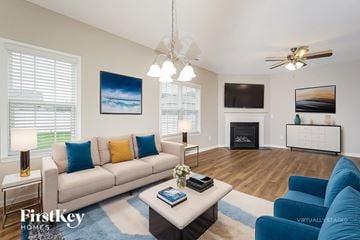 Jamestown house for rent - A living room with a white couch and a painting on the wall.