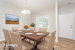 Jamestown house for rent - A dining room with a wooden table and chairs.