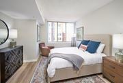 Alexandria apartment for rent - A bedroom with a large bed and a chair.