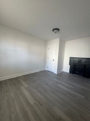 Louisville house for rent - A room with a fireplace and a door.