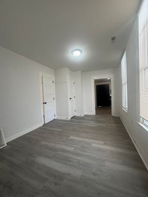 Louisville house for rent - A long hallway with a light on the ceiling and a door at the end.