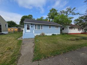 Gary house for rent - A blue house with a white door and a small porch.