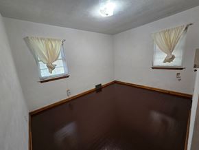Gary house for rent - A room with brown walls and a brown floor.