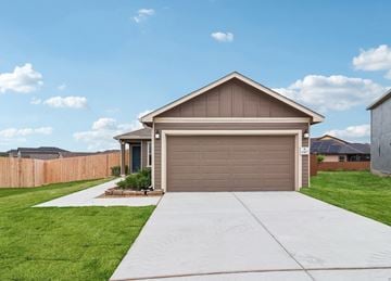 San Antonio house for rent - A house with a brown garage door and a driveway leading to it.