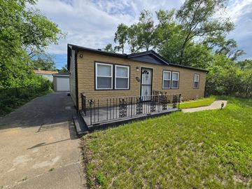 Gary house for rent - A small house with a black iron gate in front.
