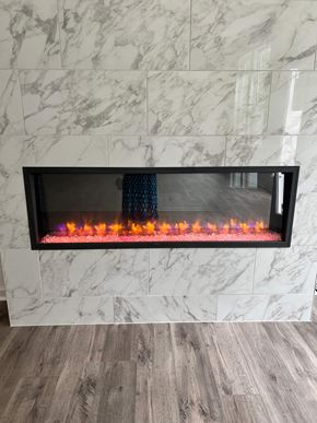 Charlotte house for rent - A fireplace with a fire burning inside it.