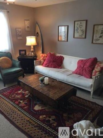 Portsmouth apartment for rent - A living room with a white couch and a wooden coffee table.