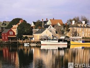 Portsmouth apartment for rent - A row of houses with boats in front of them.