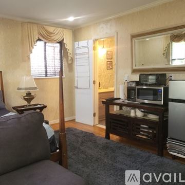 Pensacola apartment for rent - A living room with a grey couch and a stone fireplace.