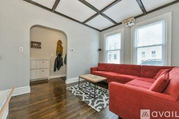 Cambridge house for rent - A living room with a red couch and a coffee table.