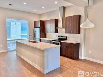 Phoenix apartment for rent - A modern kitchen with wooden cabinets and a white island.