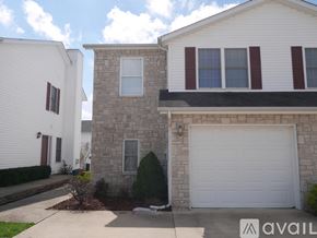 Bloomington condo for rent - A house with a white garage door and a stone wall.