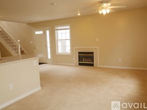 Bloomington condo for rent - A living room with a fireplace, a couch, and a television.