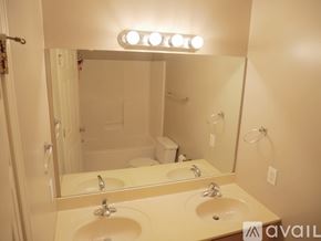 Bloomington condo for rent - A bedroom with a bed, nightstand, and a dresser with a mirror.