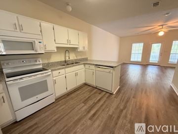 Santa Rosa Beach apartment for rent - A kitchen with granite countertops and white cabinets.