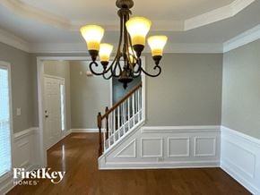 Clemmons house for rent - A chandelier hangs over a staircase in a home.