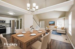 Clarksville house for rent - A dining room with a wooden table set for four.