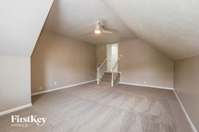 Clarksville house for rent - A spacious room with a staircase leading to the second floor.