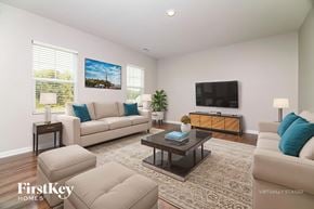 Four Oaks house for rent - A living room with a couch, a coffee table, and a television.