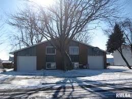 Washington house for rent - A house with a brown roof and a white garage door is surrounded by snow.