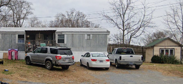 Johnson City apartment for rent - A silver SUV is parked in front of a silver car and a white car.