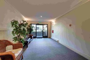 Victoria apartment for rent - A room with a couch, chair, and a plant.