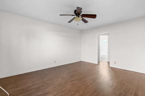Burbank apartment for rent - A room with a ceiling fan and wooden flooring.