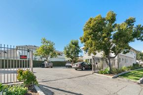 Toluca Lake apartment for rent - A gated entrance to a residential area with a car parked in front.