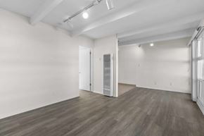 Toluca Lake apartment for rent - A room with a white wall and a wooden floor.