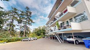 Victoria apartment for rent - A sunny day at a residential building with cars parked in the driveway.
