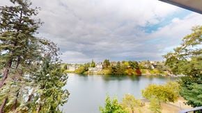 Victoria apartment for rent - A lake surrounded by trees and buildings in the distance.