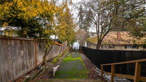 Victoria apartment for rent - A backyard with a wooden fence and a green lawn.