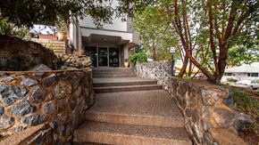 Victoria apartment for rent - A stone wall leads to a building entrance.