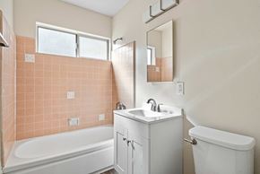 Burbank apartment for rent - A bathroom with a white tub, sink, and vanity.